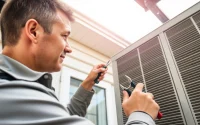 Expert AC repair service technician working on air conditioning unit in Mesa, AZ.